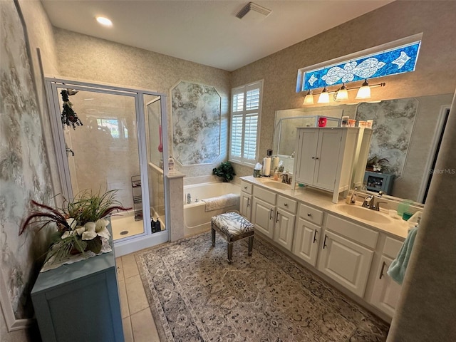 full bath with a sink, a garden tub, a shower stall, and double vanity