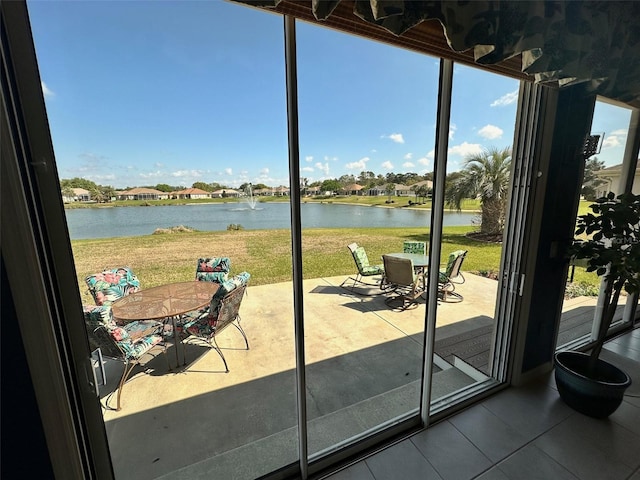 interior space featuring outdoor dining area and a water view
