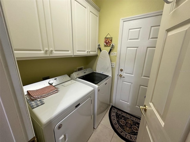 laundry area with light tile patterned floors, cabinet space, and independent washer and dryer