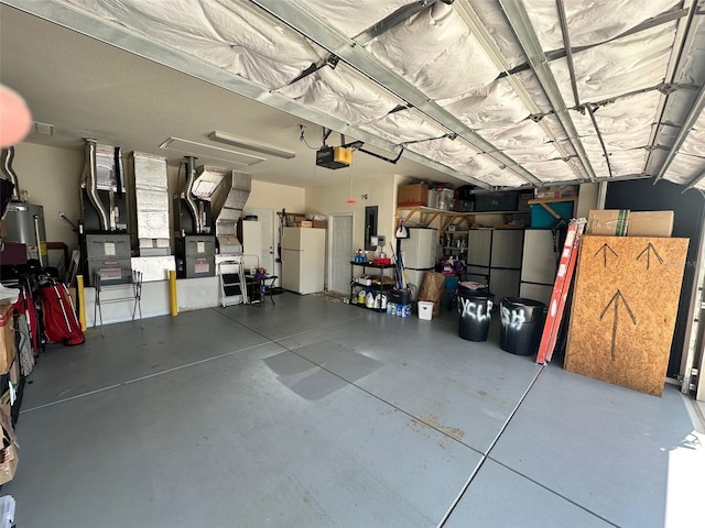 garage featuring electric panel, a garage door opener, water heater, and freestanding refrigerator