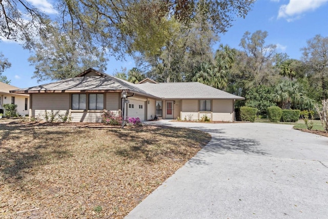 ranch-style home with an attached garage and driveway