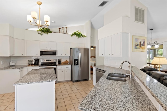 kitchen with a notable chandelier, appliances with stainless steel finishes, visible vents, and a sink