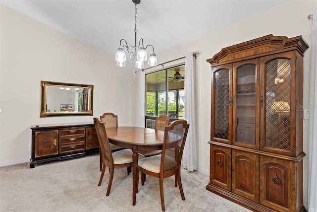 dining room featuring a notable chandelier, light colored carpet, and baseboards