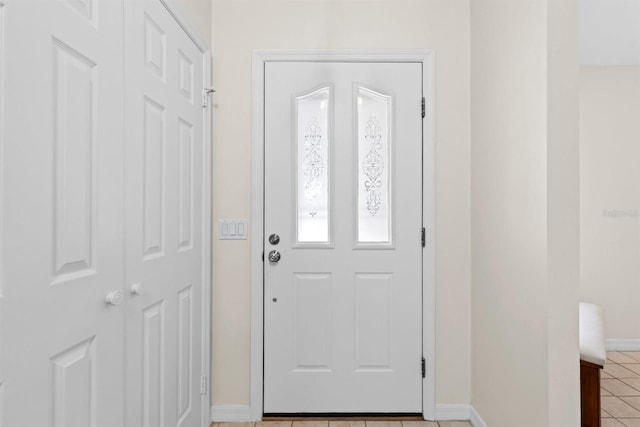 entryway featuring light tile patterned floors and baseboards