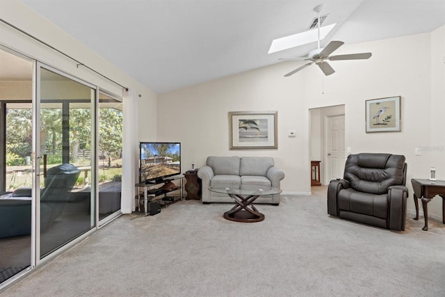 living area featuring baseboards, visible vents, vaulted ceiling with skylight, ceiling fan, and carpet flooring