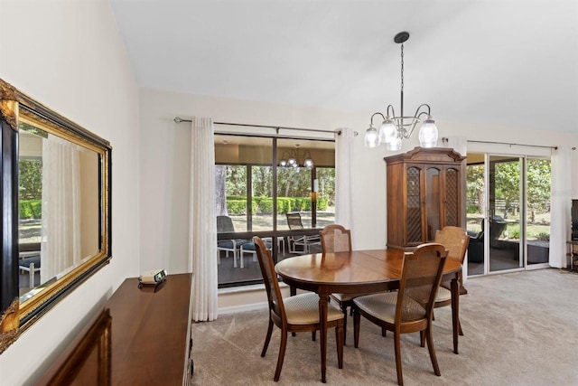 dining space with carpet floors and a notable chandelier