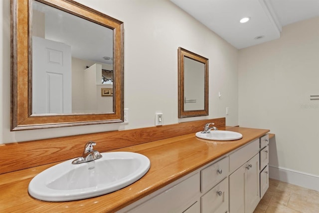 full bath featuring tile patterned floors, recessed lighting, double vanity, and a sink