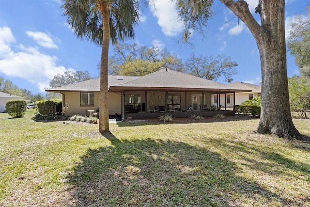 rear view of house featuring a yard