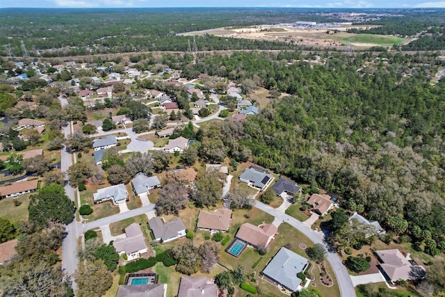 aerial view featuring a forest view and a residential view