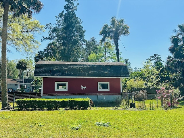 view of home's exterior with a yard and fence