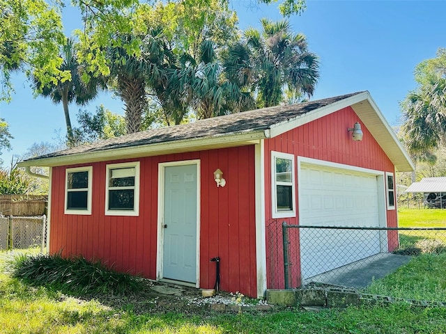 view of outbuilding featuring an outbuilding and fence