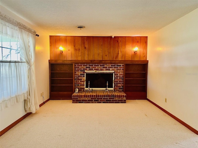 living room with visible vents, baseboards, a textured ceiling, and a fireplace