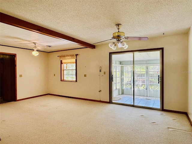 unfurnished room with beamed ceiling, carpet flooring, a textured ceiling, and a healthy amount of sunlight