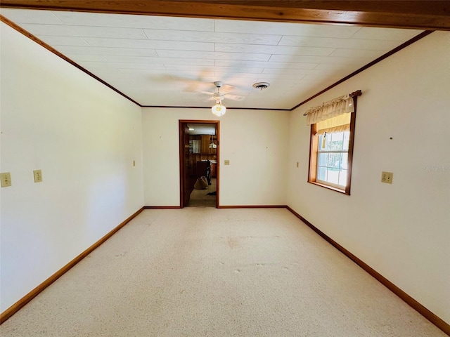 unfurnished room with visible vents, baseboards, and crown molding