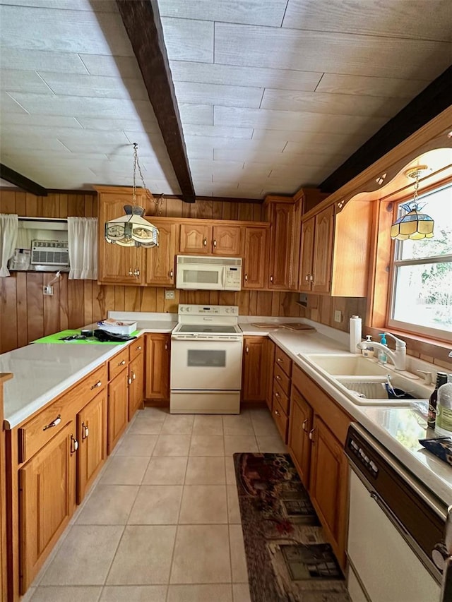 kitchen with brown cabinets, a sink, white appliances, light tile patterned flooring, and light countertops