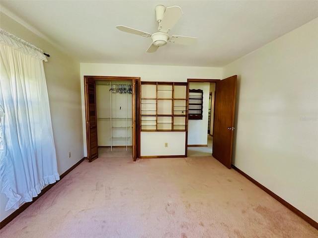 unfurnished bedroom with light colored carpet, baseboards, a closet, and ceiling fan