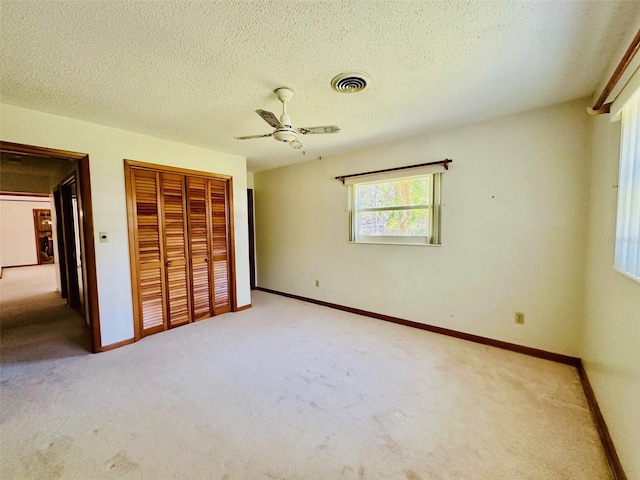 unfurnished bedroom with visible vents, baseboards, carpet, and a closet