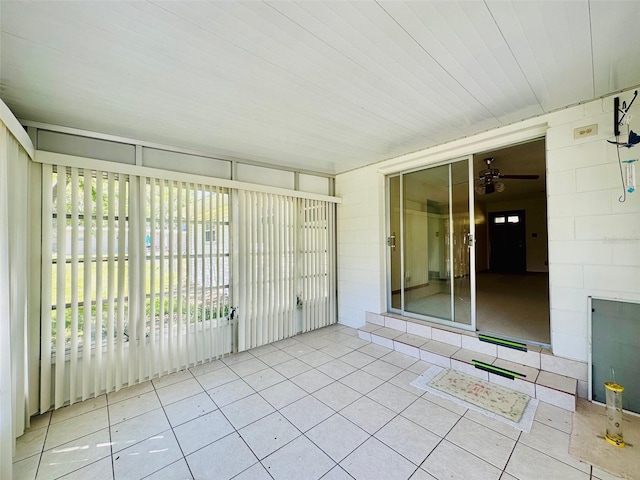 unfurnished sunroom with a ceiling fan