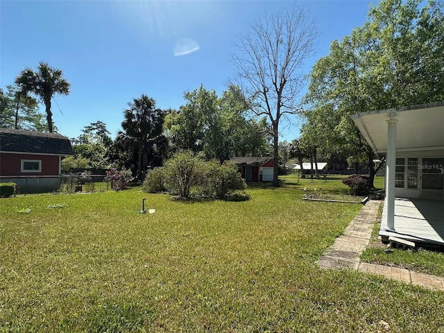 view of yard featuring an outbuilding and a storage unit