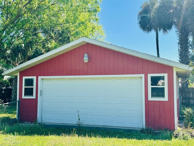 detached garage featuring fence