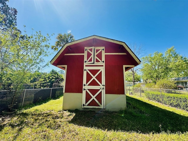 view of outbuilding featuring an outbuilding and fence