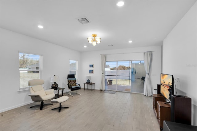 sitting room with recessed lighting, a chandelier, and light wood-style flooring