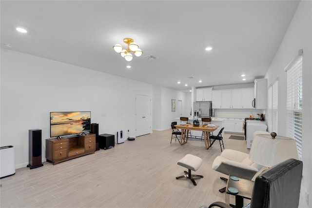 interior space with light wood-style floors, recessed lighting, visible vents, and baseboards