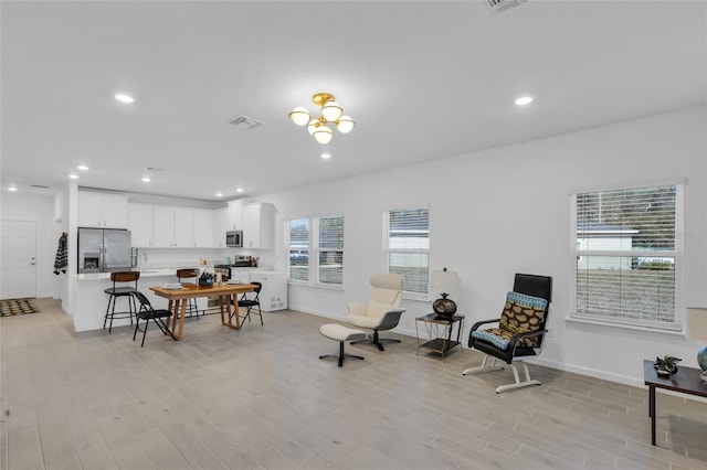 dining room with recessed lighting and light wood-style flooring