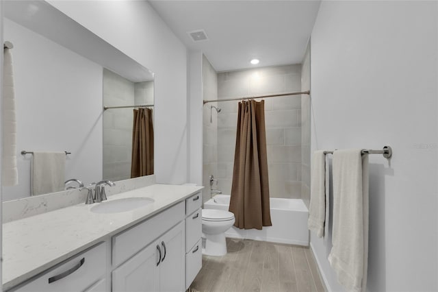 full bathroom with visible vents, toilet, shower / tub combo, wood finished floors, and vanity