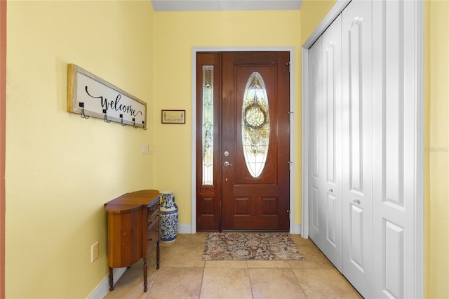 tiled entrance foyer with baseboards