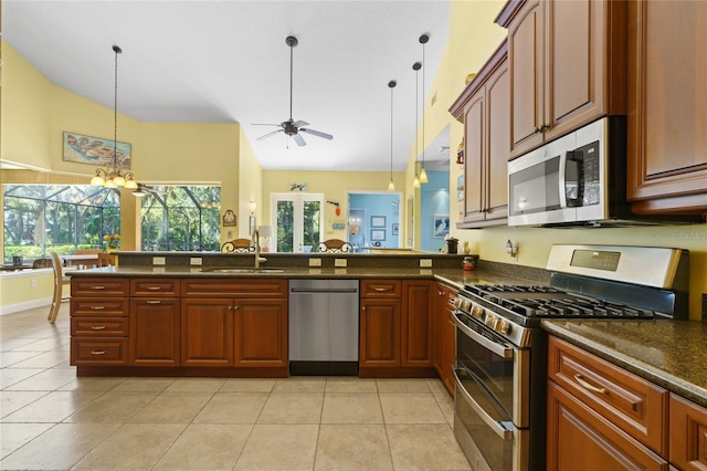 kitchen with ceiling fan with notable chandelier, decorative light fixtures, a sink, stainless steel appliances, and light tile patterned floors