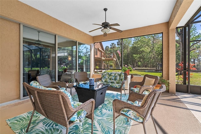 sunroom / solarium with a healthy amount of sunlight and ceiling fan