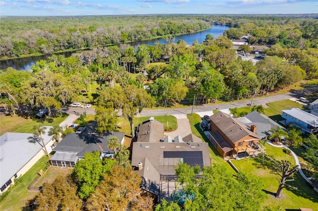 drone / aerial view with a forest view, a water view, and a residential view