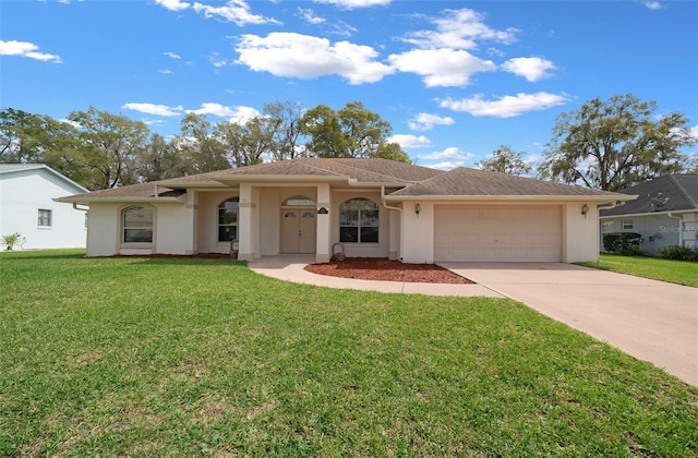 view of front of property with a garage, concrete driveway, a front yard, and stucco siding