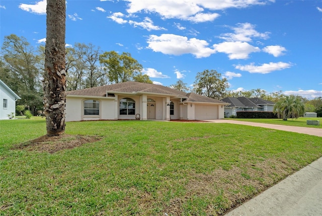 ranch-style home featuring a garage, concrete driveway, a front yard, and stucco siding