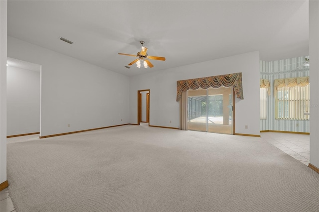 unfurnished living room with visible vents, carpet floors, baseboards, and a ceiling fan