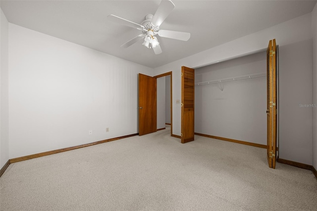 unfurnished bedroom featuring light carpet, a closet, and baseboards