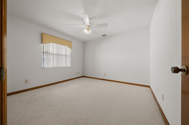 spare room with visible vents, baseboards, ceiling fan, and carpet flooring