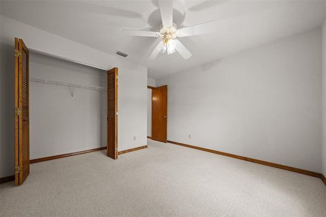 unfurnished bedroom featuring visible vents, ceiling fan, baseboards, light carpet, and a closet