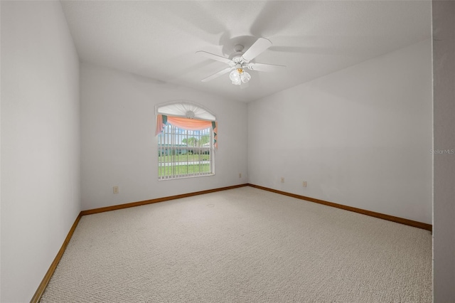 unfurnished room with baseboards, a ceiling fan, and carpet flooring