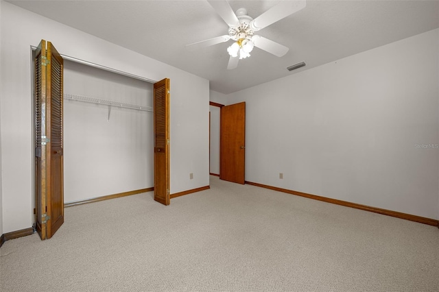 unfurnished bedroom featuring a ceiling fan, visible vents, baseboards, a closet, and light colored carpet