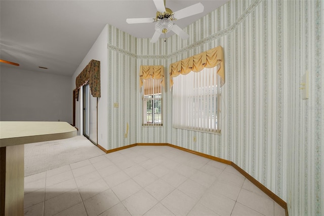 unfurnished room featuring wallpapered walls, baseboards, and ceiling fan