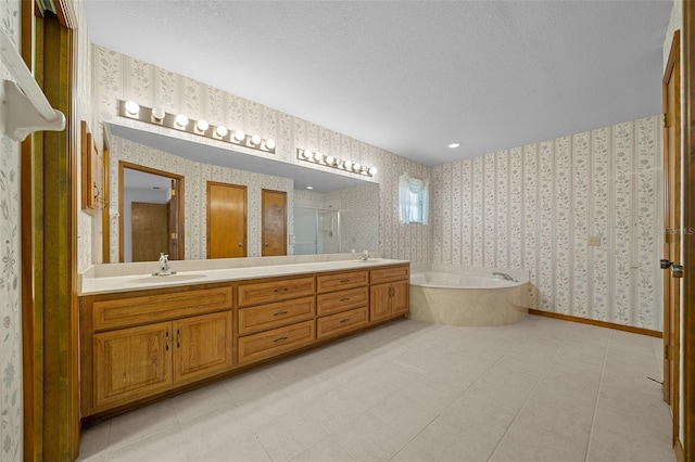 full bathroom featuring a garden tub, a stall shower, a sink, wallpapered walls, and double vanity