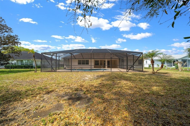 back of property featuring a lanai, a yard, an outdoor pool, and a patio