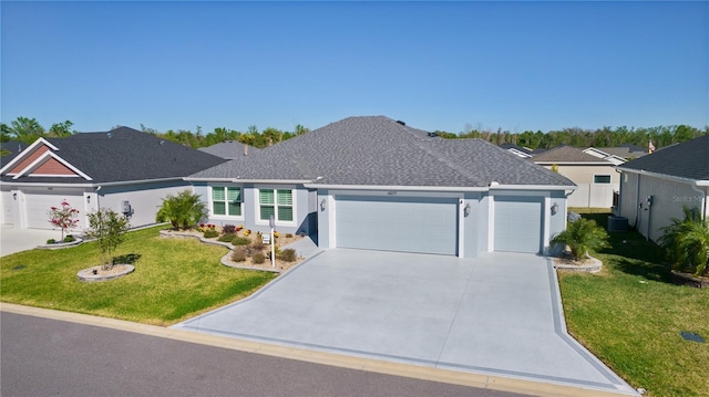 single story home with stucco siding, a front yard, concrete driveway, and an attached garage