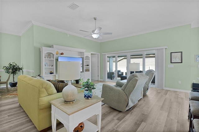 living area featuring crown molding, light wood-style flooring, baseboards, and ceiling fan