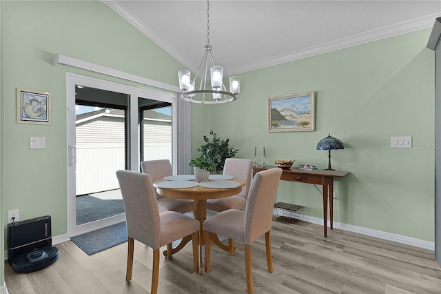 dining space with baseboards, light wood finished floors, a chandelier, and ornamental molding