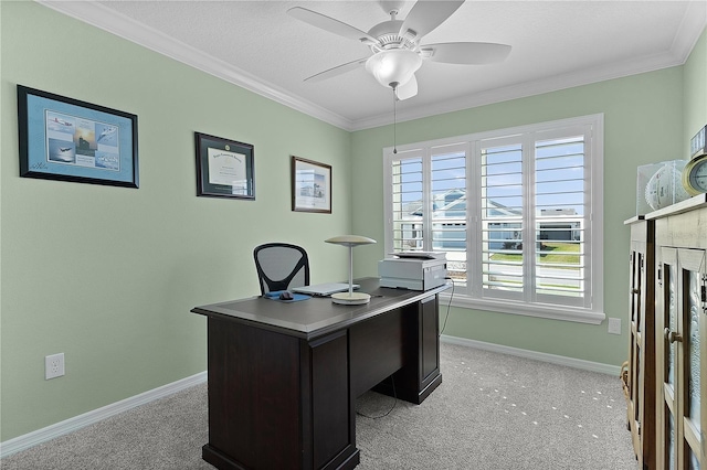 office featuring light colored carpet, ornamental molding, and a ceiling fan