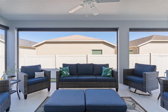 sunroom with plenty of natural light and ceiling fan