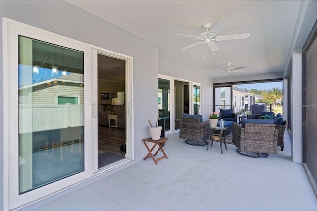 sunroom / solarium with a ceiling fan